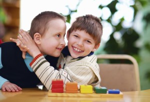two boys hugging with colored blocks