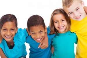 kids in multicolored shirts smiling