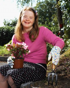 teenage girl (14-17) with down syndrome gardening