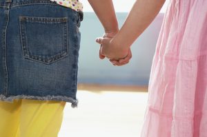 two young girls holding hands