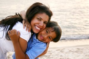 Mother Hugging Son Tightly on the Beach