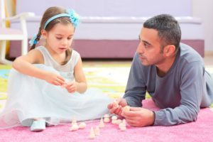 Father And Daughter Playing With Toys